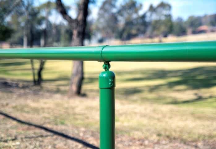 Single handrail with green finish installed in park